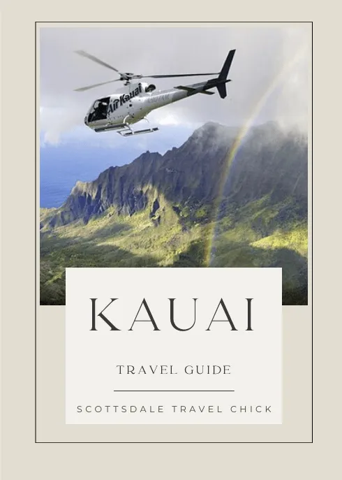 kauai travel guide Helicopter flying over Kauai mountains with rainbow
