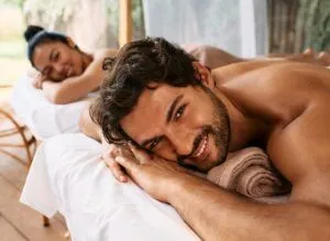 Beautiful couple getting a back massage on Bali resort, romantic weekend and relax. Couple massage