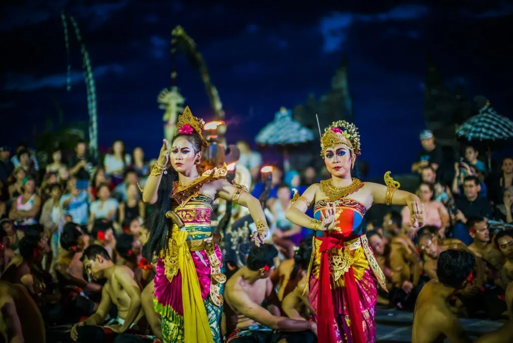 The Best Time to Visit Bali (and Why) Two women perform traditional Balinese dance in colorful costumes during a festival.