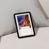 E-book on pillow, travel guide cover visible.