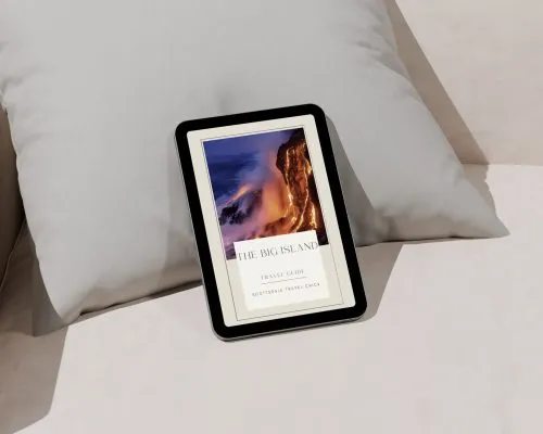 E-book on pillow, travel guide cover visible.