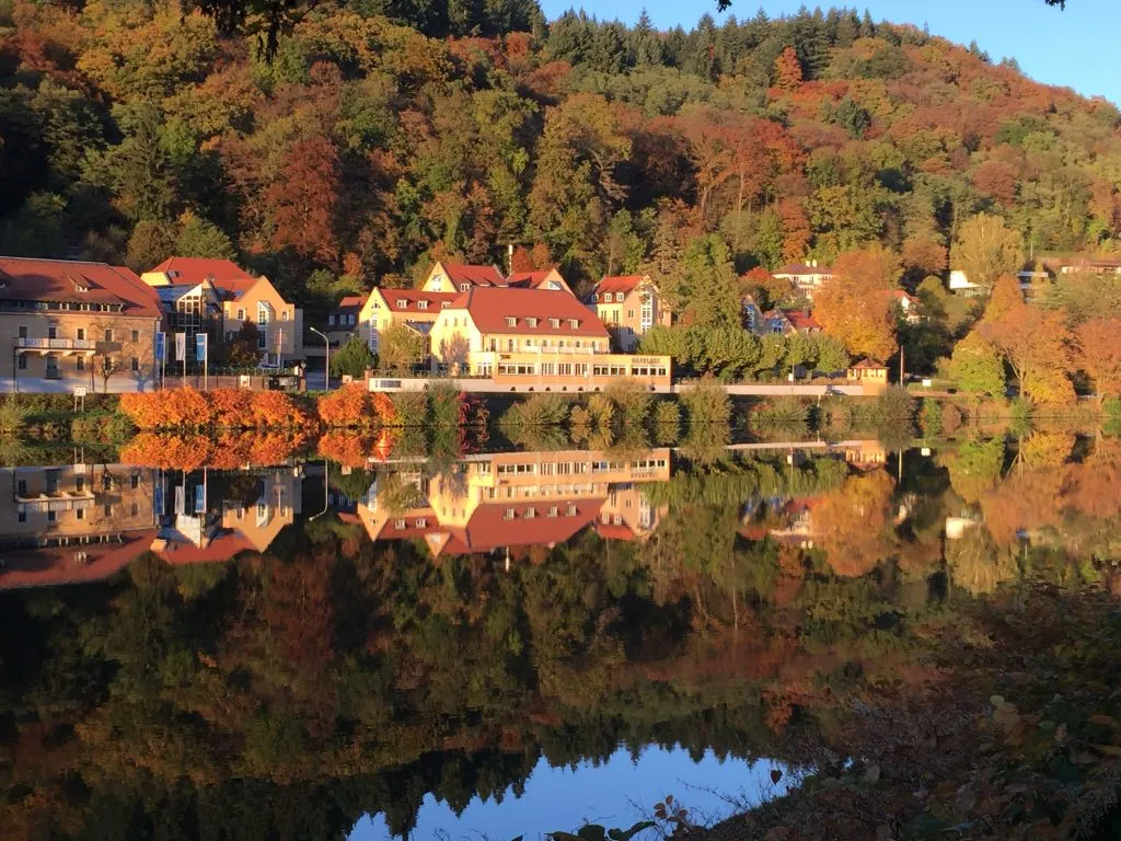 Scenic autumn landscape with colorful trees and houses.