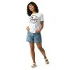 womens-relaxed-t-shirt-white-front-685479788e1d1.jpg Smiling woman in travel-themed shirt and denim shorts