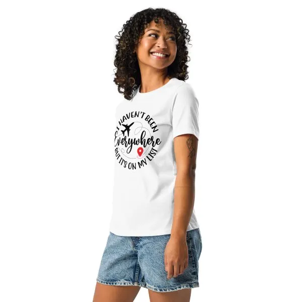 womens-relaxed-t-shirt-white-left-front-685479788d19c.jpg Woman in travel-themed t-shirt and denim shorts smiling.
