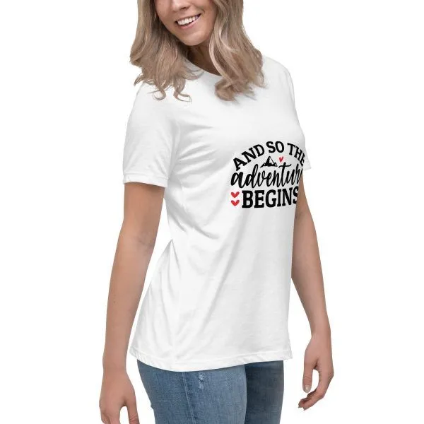 Woman wearing 'adventure begins' t-shirt smiling.