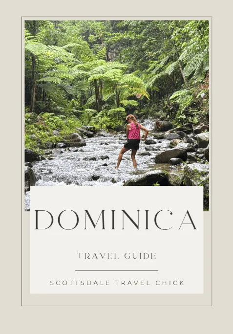 Woman crossing river in Dominica jungle.