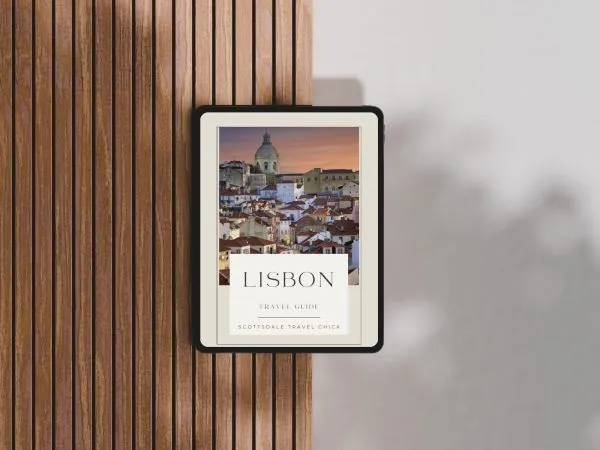 Lisbon Travel Guide Cover Mockup Tablet displaying Lisbon travel guide on wooden table.