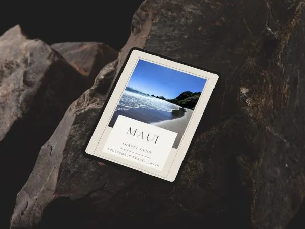 Maui Travel Guide-ipad-pro-mockup-on-rugged-stone-surface-min Tablet displaying Maui travel guide cover.