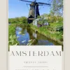 amsterdam travel guide Amsterdam windmill by river under blue sky