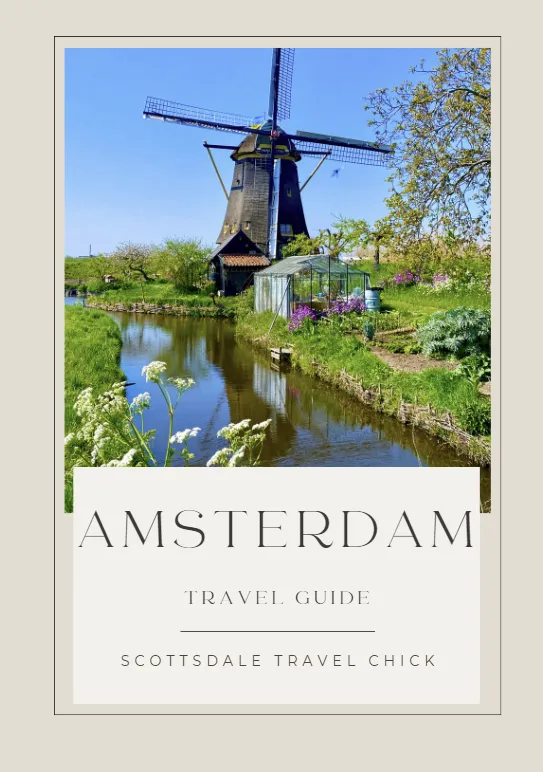 amsterdam travel guide Amsterdam windmill by river under blue sky